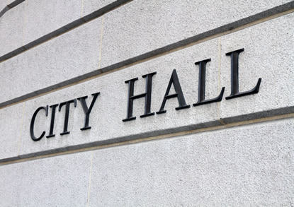 city hall sign on government building