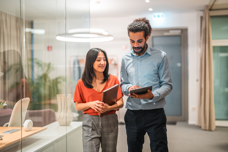 two colleagues looking at tablet in an office